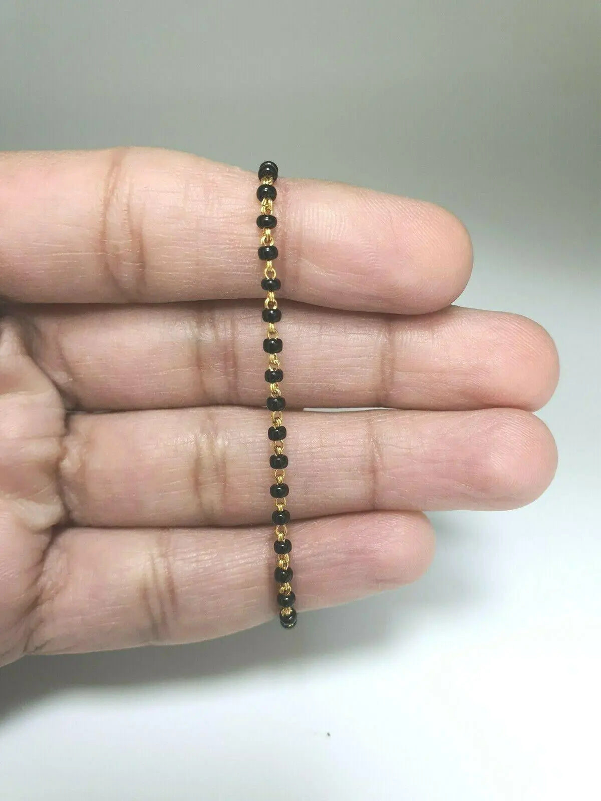 18ct Yellow Gold Baby Bracelet Black Beaded With Diamond Cut Design 