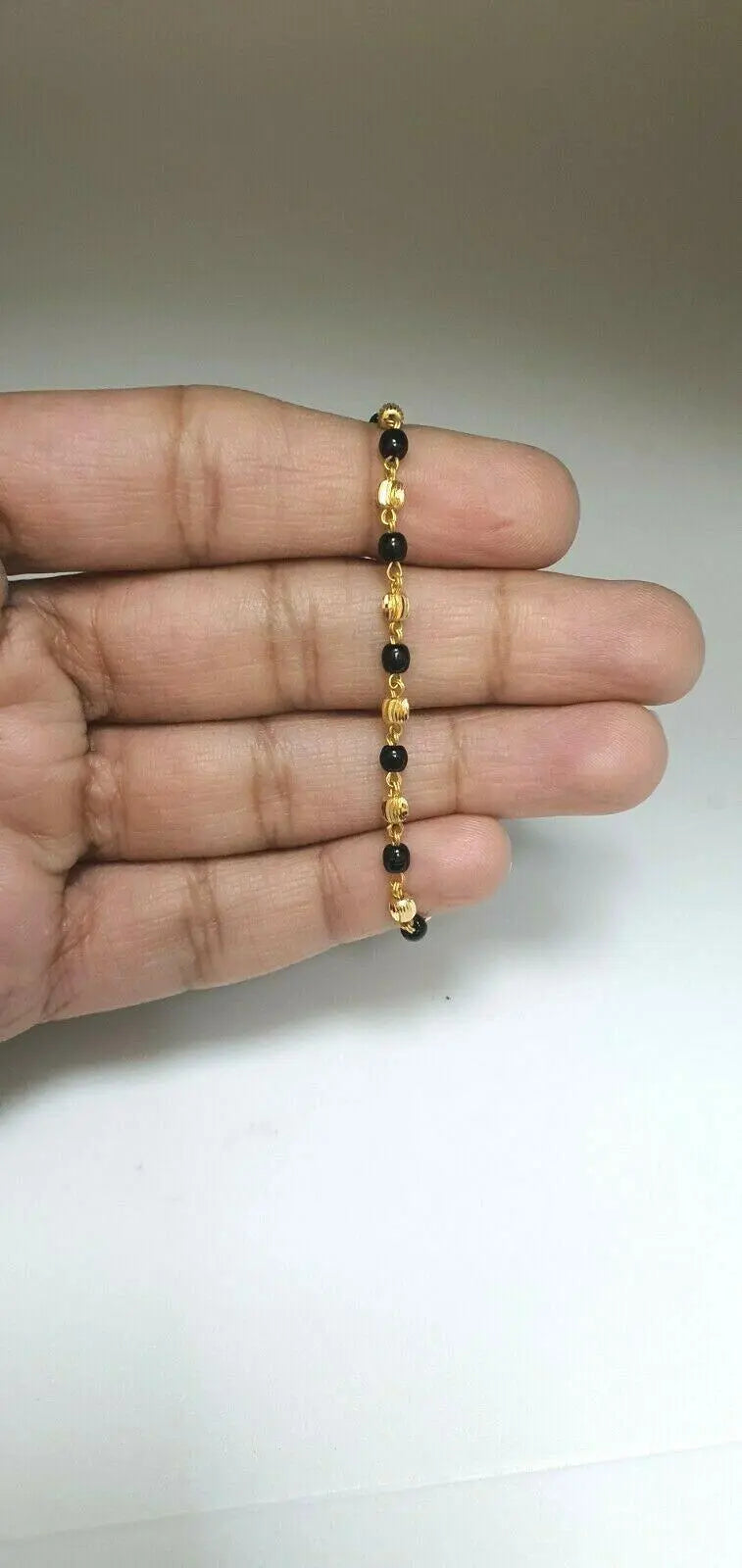 22ct Yellow Gold Baby Bracelet Black-beads With Diamond Cut Design 